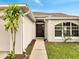 Inviting home entrance with an arched window, elegant front door, and landscaped walkway at 440 Peppermill Cir, Kissimmee, FL 34758