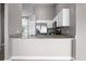 Modern kitchen with stainless steel appliances, granite countertops, and white cabinets at 440 Peppermill Cir, Kissimmee, FL 34758