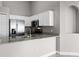 Bright kitchen featuring granite counters, stainless steel appliances, and white cabinetry at 440 Peppermill Cir, Kissimmee, FL 34758