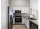 Well-lit kitchen featuring stainless steel appliances and granite countertops at 440 Peppermill Cir, Kissimmee, FL 34758