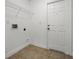Bright laundry room with tile floor and shelving at 440 Peppermill Cir, Kissimmee, FL 34758