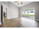 Bright living room with wood floors, ceiling fan, and sliding glass doors to the lanai at 440 Peppermill Cir, Kissimmee, FL 34758
