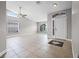 Open-concept living room with tile flooring, a high ceiling, natural light, and a ceiling fan at 440 Peppermill Cir, Kissimmee, FL 34758