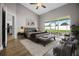 Staged main bedroom with a ceiling fan, sliding glass doors to patio, and doorway to the kitchen at 440 Peppermill Cir, Kissimmee, FL 34758