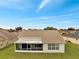 Aerial view of the rear of the home showing the screened in patio and lawn at 440 Peppermill Cir, Kissimmee, FL 34758