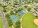 Aerial view of community tennis and basketball courts with well-maintained landscaping at 440 Peppermill Cir, Kissimmee, FL 34758