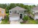 Aerial view of a lovely two-story home with a well-maintained yard and mature trees at 4697 Golden Beach Ct, Kissimmee, FL 34746
