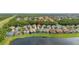 Aerial view showcasing homes with screened pools near a tranquil lake, highlighting the community's amenities and location at 4697 Golden Beach Ct, Kissimmee, FL 34746