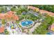 Aerial view showcasing the basketball court and playground surrounded by tropical trees and the community clubhouse at 4697 Golden Beach Ct, Kissimmee, FL 34746