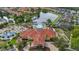 Aerial view of a luxurious clubhouse, pool, playground, and scenic lake surrounded by lush landscaping and colorful townhomes at 4697 Golden Beach Ct, Kissimmee, FL 34746