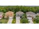 Aerial shot showcases the neighborhood, mature trees, and green lawns at 4697 Golden Beach Ct, Kissimmee, FL 34746