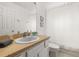 Bathroom sink and mirror with a white shower curtain at 4697 Golden Beach Ct, Kissimmee, FL 34746