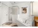 Bright bathroom featuring a soaking tub, glass enclosed shower, and beach themed decor at 4697 Golden Beach Ct, Kissimmee, FL 34746