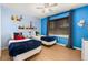 Bright bedroom featuring themed decor, ceiling fan, and window with blinds at 4697 Golden Beach Ct, Kissimmee, FL 34746