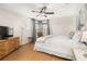 Serene bedroom with hardwood floors, ceiling fan, and a large bed with white bedding at 4697 Golden Beach Ct, Kissimmee, FL 34746