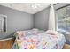 Bright bedroom with two twin beds, wood-look floors, and a ceiling fan provides a comfortable retreat at 4697 Golden Beach Ct, Kissimmee, FL 34746