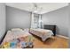 Bright bedroom with two twin beds, wood-look floors, and a ceiling fan provides a comfortable retreat at 4697 Golden Beach Ct, Kissimmee, FL 34746