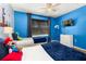 Bright bedroom featuring themed decor, ceiling fan, and TV at 4697 Golden Beach Ct, Kissimmee, FL 34746
