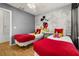 Bright bedroom featuring twin beds with red bedding and Mickey Mouse wall art at 4697 Golden Beach Ct, Kissimmee, FL 34746