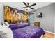 Bedroom with two twin beds, mural, wood-look floors, ceiling fan, and window at 4697 Golden Beach Ct, Kissimmee, FL 34746