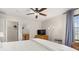 Bedroom with ceiling fan, dresser, and a view into the ensuite bathroom and walk in closet at 4697 Golden Beach Ct, Kissimmee, FL 34746