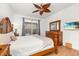 Comfortable bedroom with a tropical-themed ceiling fan and detailed wood furniture at 4697 Golden Beach Ct, Kissimmee, FL 34746