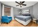 Bedroom featuring a ceiling fan, window with blinds, and an accent chair at 4697 Golden Beach Ct, Kissimmee, FL 34746