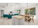Open-concept dining area featuring a modern chandelier and bright living area at 4697 Golden Beach Ct, Kissimmee, FL 34746