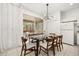 Bright dining room with a large glass table and sliding glass doors at 4697 Golden Beach Ct, Kissimmee, FL 34746