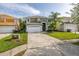 Beautifully landscaped two-story home with a spacious driveway and well-manicured lawn at 4697 Golden Beach Ct, Kissimmee, FL 34746