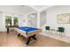 Spacious entertainment area with a pool table, foosball table, and cozy seating at 4697 Golden Beach Ct, Kissimmee, FL 34746
