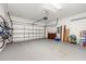 Spacious two-car garage with epoxy flooring, overhead door, and ample storage space for vehicles and equipment at 4697 Golden Beach Ct, Kissimmee, FL 34746