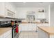 Bright kitchen with white cabinets, modern appliances, and open layout at 4697 Golden Beach Ct, Kissimmee, FL 34746