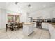 Spacious kitchen featuring an island, stainless steel appliances, and dining area at 4697 Golden Beach Ct, Kissimmee, FL 34746
