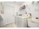 Clean laundry room with washer, dryer, utility sink, and plenty of storage space at 4697 Golden Beach Ct, Kissimmee, FL 34746