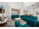 Open concept living room with high ceilings, plenty of natural light and modern teal furniture at 4697 Golden Beach Ct, Kissimmee, FL 34746