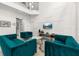 Cozy living room features modern decor, a television, and plush teal seating for relaxing at 4697 Golden Beach Ct, Kissimmee, FL 34746