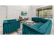 Bright living room boasts modern furniture, neutral decor, and sliding glass doors to the outdoor living space at 4697 Golden Beach Ct, Kissimmee, FL 34746