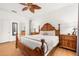 Spacious main bedroom featuring warm wood furniture and ensuite bath at 4697 Golden Beach Ct, Kissimmee, FL 34746