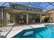 Spacious covered patio overlooking the pool and outdoor entertaining area at 4697 Golden Beach Ct, Kissimmee, FL 34746