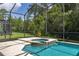 Screened-in pool and spa surrounded by lush greenery, creating a private and relaxing outdoor oasis at 4697 Golden Beach Ct, Kissimmee, FL 34746