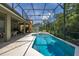 Screened-in pool area with inground pool, spa, and a covered patio for entertaining at 4697 Golden Beach Ct, Kissimmee, FL 34746