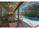 A tranquil screened-in pool area with covered patio, seating, and lush greenery, creating a relaxing outdoor space at 4697 Golden Beach Ct, Kissimmee, FL 34746