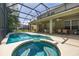 Screened in pool area with a hot tub, swimming pool, and covered patio with ceiling fans, ideal for outdoor living at 4697 Golden Beach Ct, Kissimmee, FL 34746