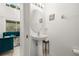 Stylish powder room with a pedestal sink, modern fixtures and natural light at 4697 Golden Beach Ct, Kissimmee, FL 34746