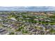 Aerial view of a neighborhood with a pond in the background and houses with well-maintained landscaping at 4952 Creekside Park Ave, Orlando, FL 32811