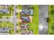 Bird's-eye view of a home with a well-manicured lawn, sitting next to a pond and neighborhood street at 4952 Creekside Park Ave, Orlando, FL 32811