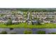 Scenic aerial view of a suburban neighborhood with well-maintained homes and lush green lawns bordering a peaceful canal at 4952 Creekside Park Ave, Orlando, FL 32811