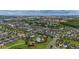 Wide aerial shot of a community featuring homes, waterways, community pool, and cityscape in the distance at 4952 Creekside Park Ave, Orlando, FL 32811