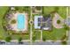 Overhead view of a community pool, amenity center, and surrounding landscape in a well-maintained neighborhood at 4952 Creekside Park Ave, Orlando, FL 32811